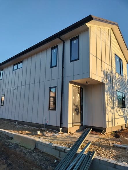 Sunlit exterior house repaint with crisp trim